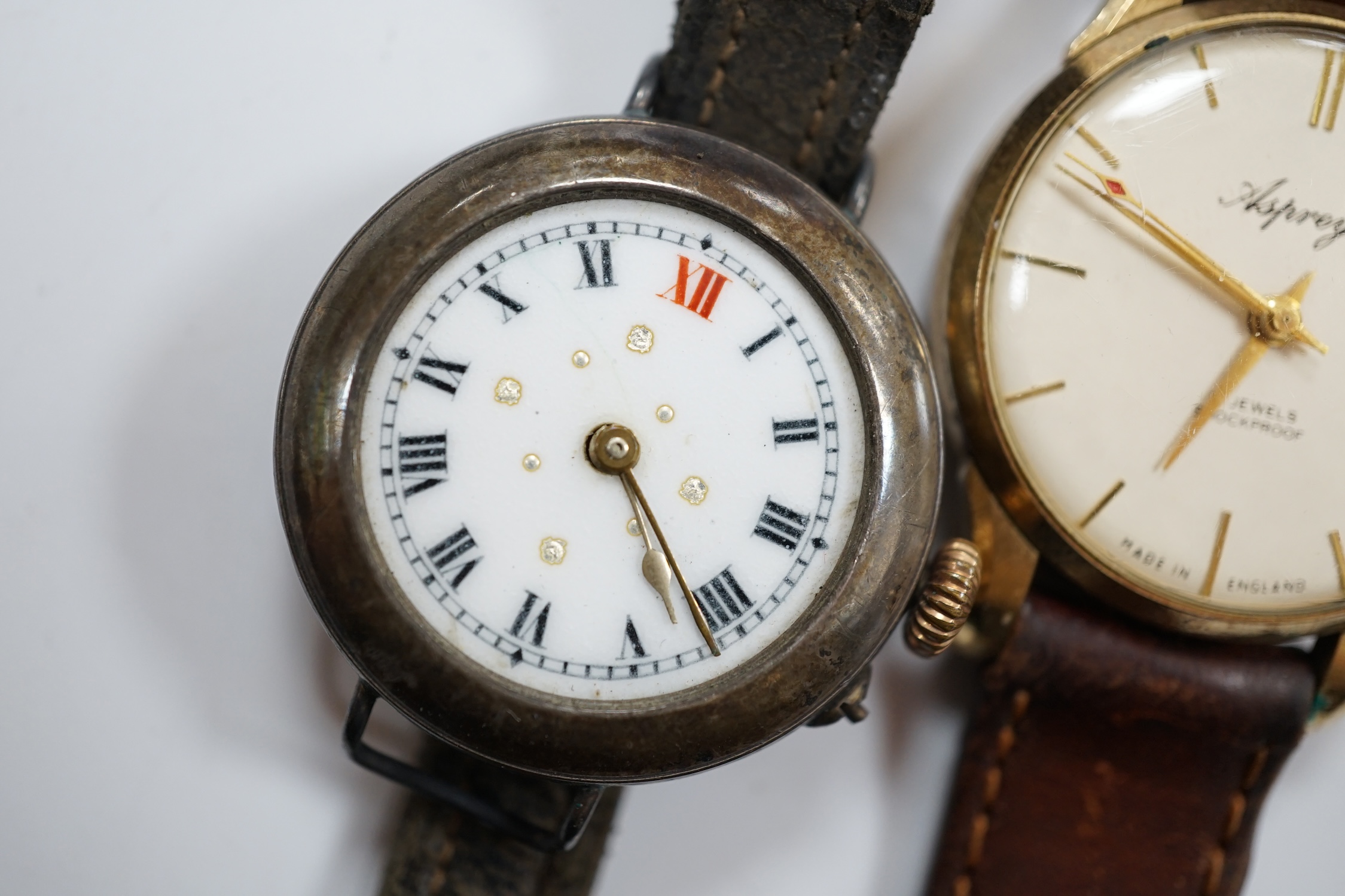 A gentleman's 9ct gold manual wind wrist watch, retailed by Asprey, together with a silver wrist watch and a mother of pearl cased Hebdomas pocket watch. Condition - poor to fair